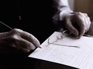 elderly man writing