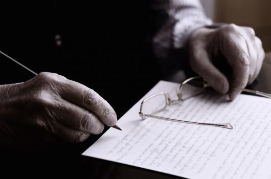 elderly man writing